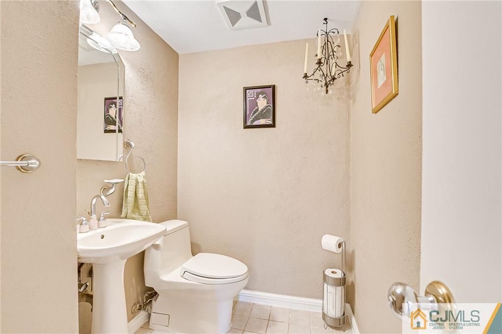 72 Monroe Avenue Edison, NJ 08820 - Photo 17 of 35 a bathroom with a sink mirror and toilet