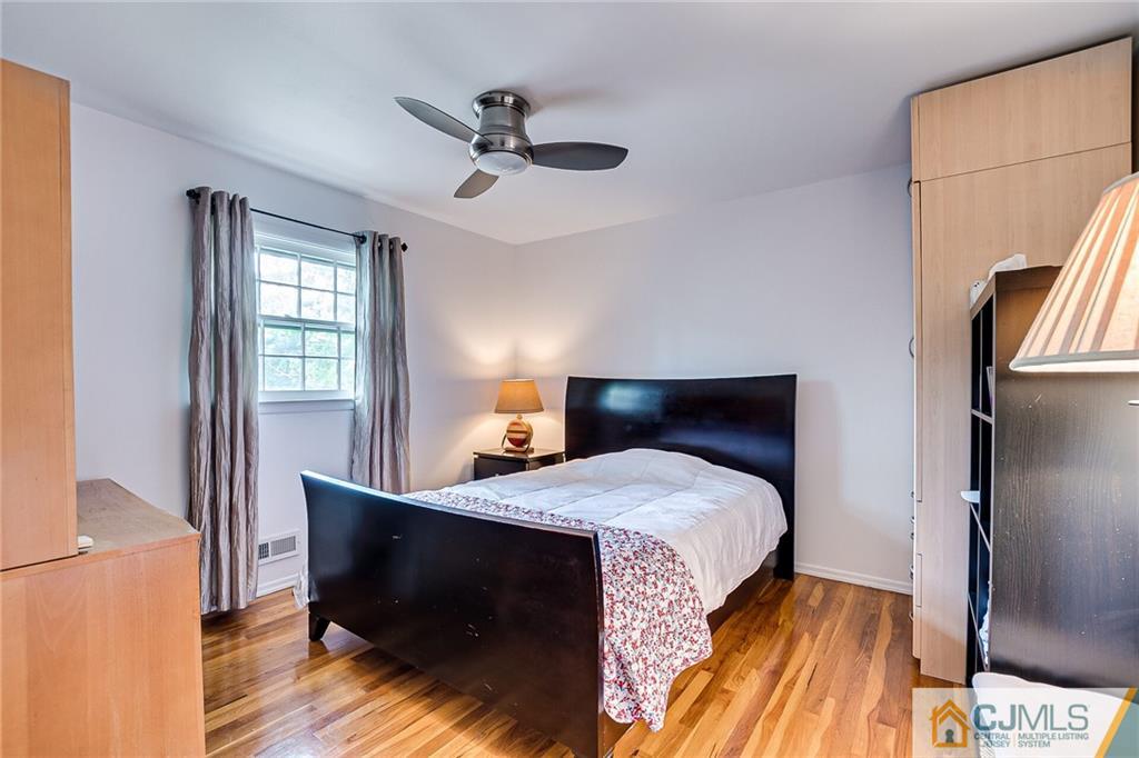 72 Monroe Avenue Edison, NJ 08820 - Photo 22 of 35 a bedroom with a bed and wooden floor