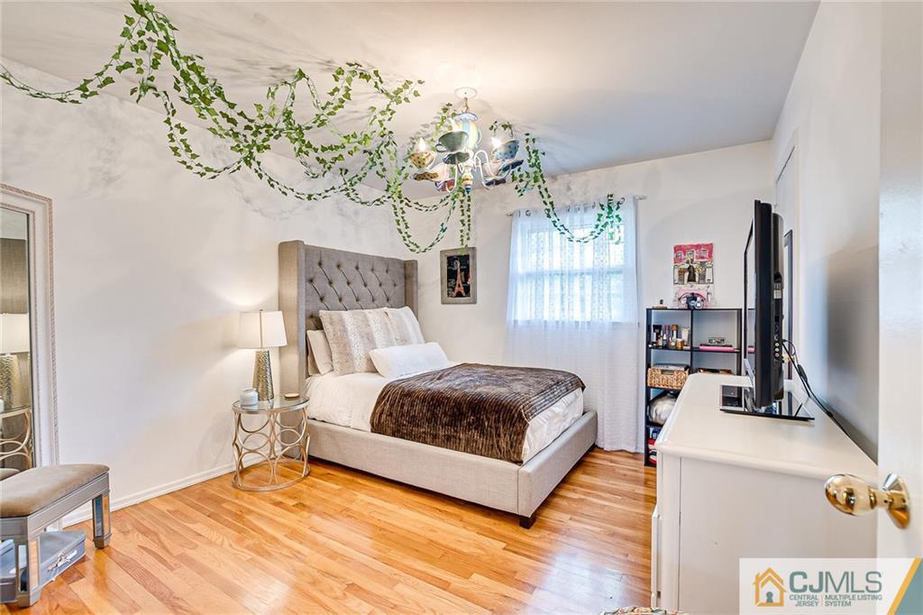 72 Monroe Avenue Edison, NJ 08820 - Photo 24 of 35 a bedroom with a bed chandelier and a window