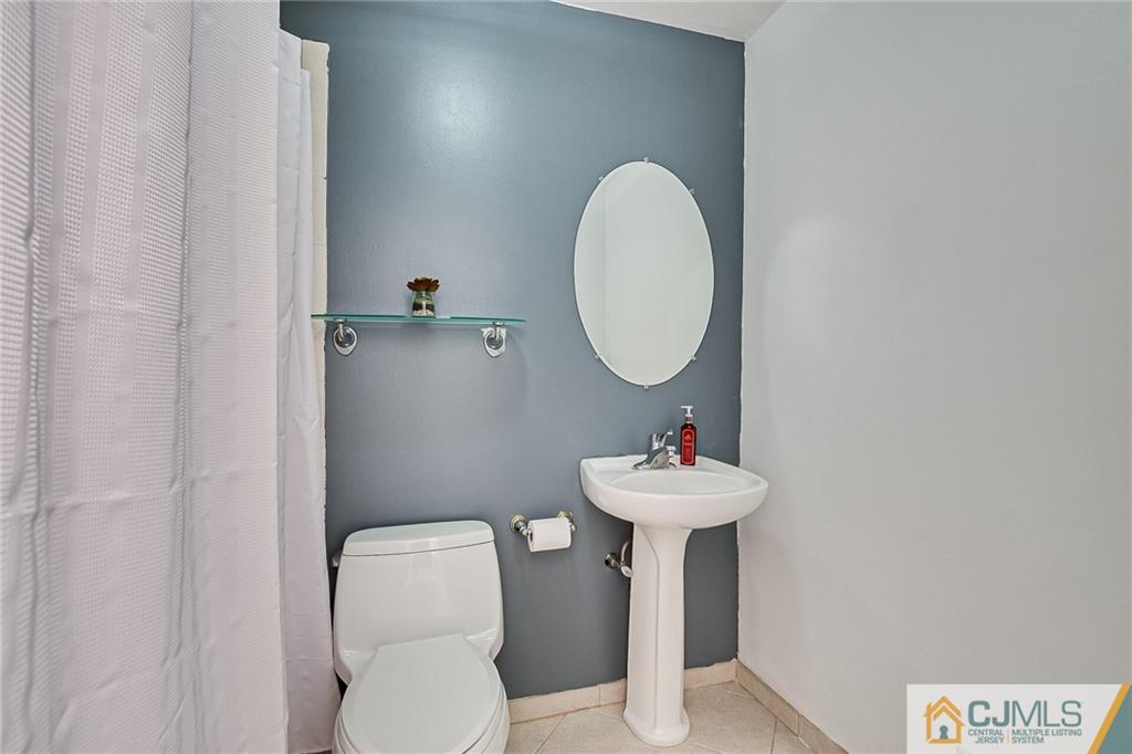 72 Monroe Avenue Edison, NJ 08820 - Photo 26 of 35 a bathroom with a sink mirror and toilet