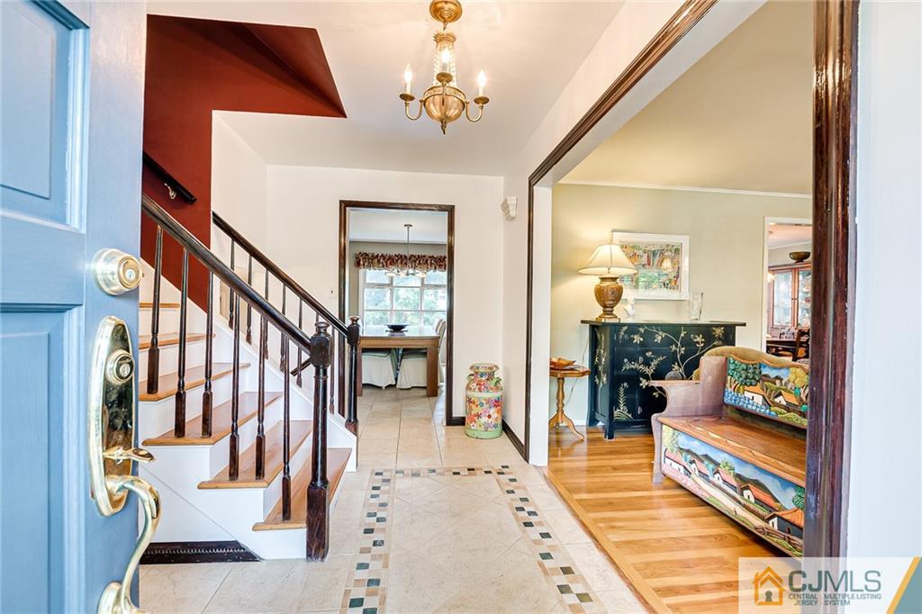 72 Monroe Avenue Edison, NJ 08820 - Photo 4 of 35 a view of an entryway with wooden floor and a chandelier