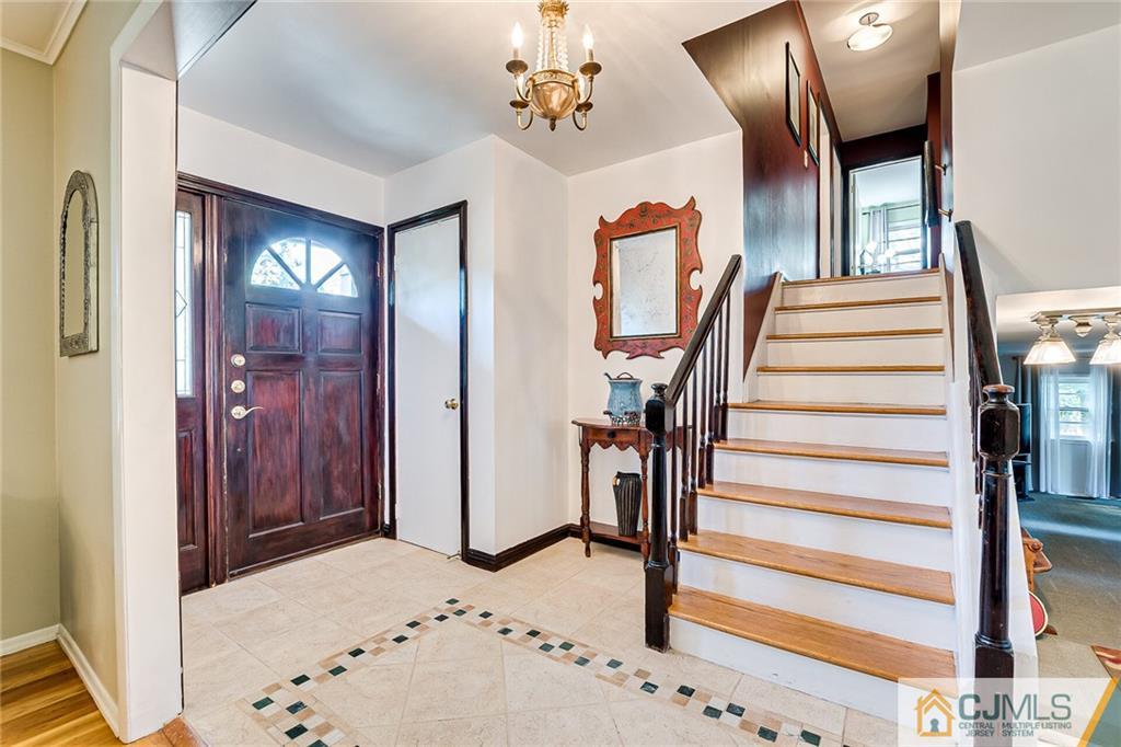 72 Monroe Avenue Edison, NJ 08820 - Photo 5 of 35 a view of a hallway with wooden floor and staircase