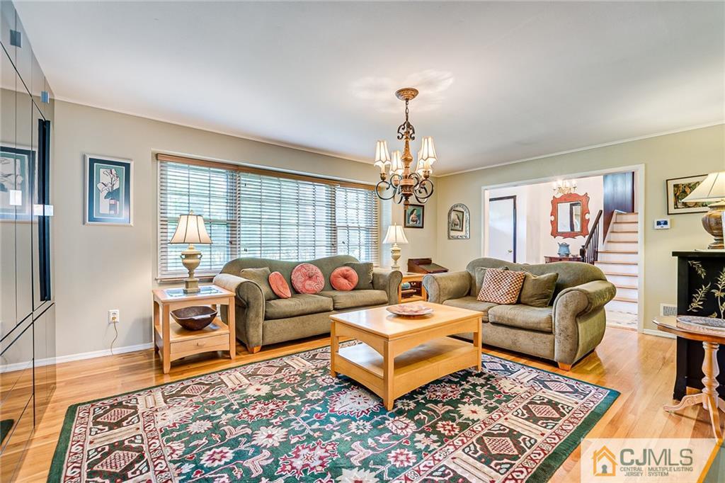 72 Monroe Avenue Edison, NJ 08820 - Photo 6 of 35 a living room with furniture a rug and a flat screen tv