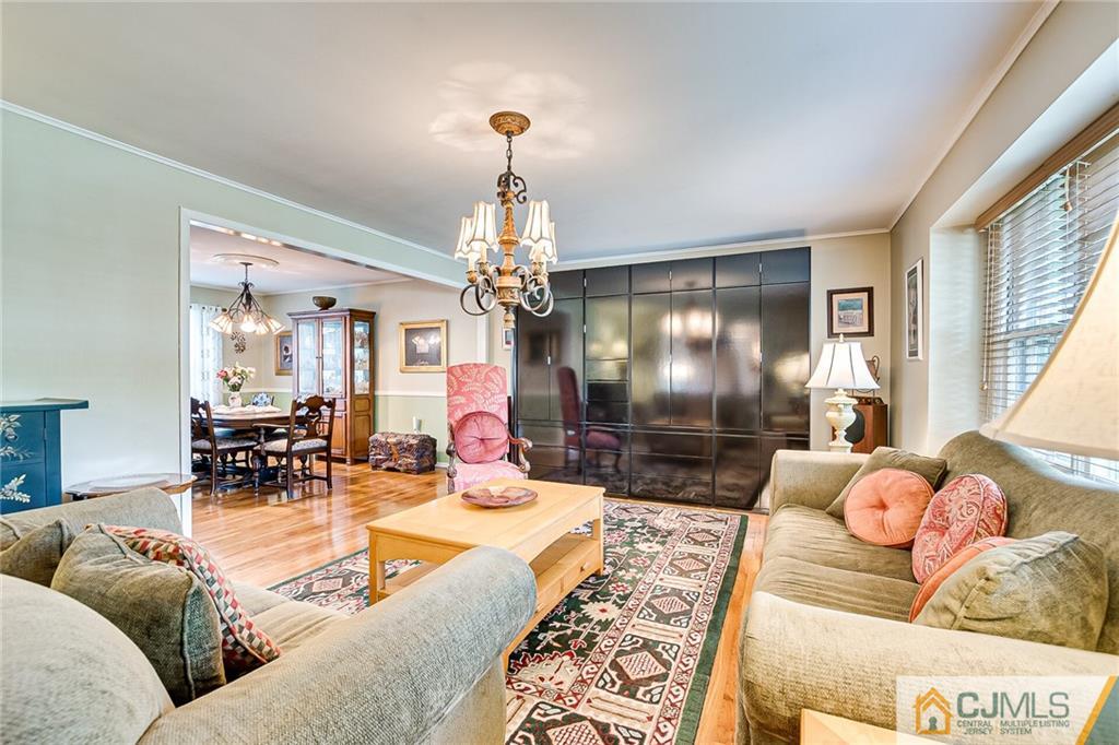 72 Monroe Avenue Edison, NJ 08820 - Photo 7 of 35 a living room with furniture and a chandelier