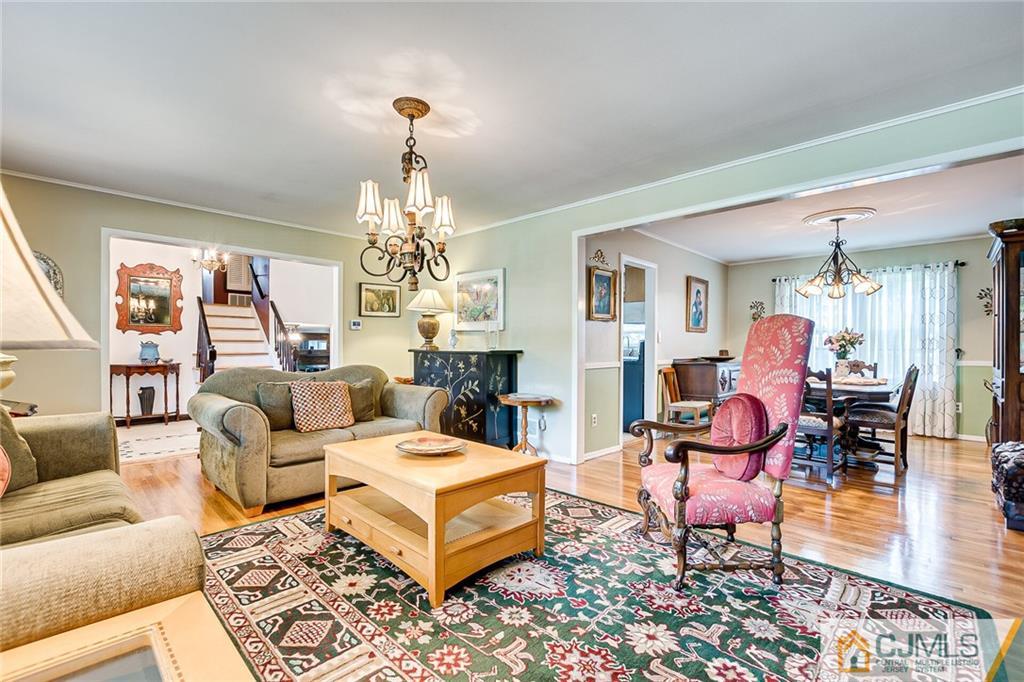 72 Monroe Avenue Edison, NJ 08820 - Photo 8 of 35 a living room with furniture and a chandelier