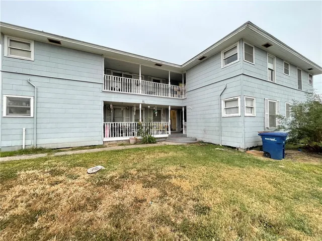 a view of a house with pool and sitting area