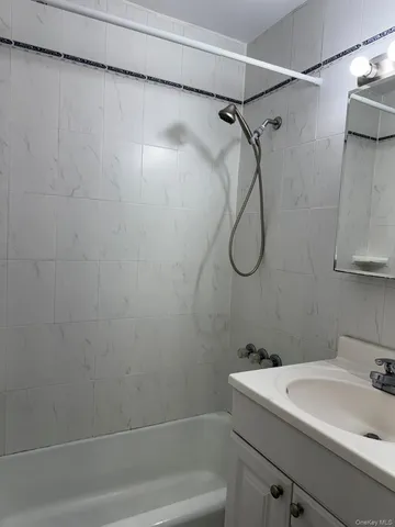 a bathroom with a sink a bath tub and a shower