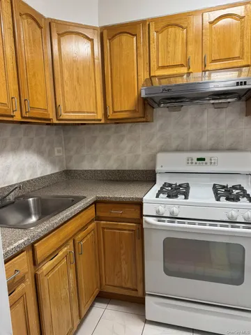 a kitchen with granite countertop cabinets stainless steel appliances and a sink
