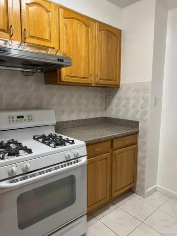 a stove top oven sitting inside of a kitchen