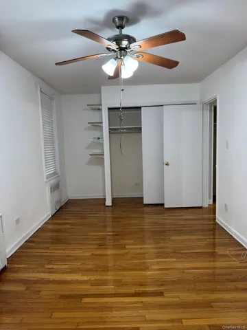 a view of an empty room with a ceiling fan