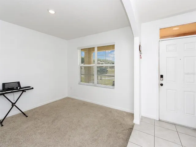 a kitchen with a table chairs refrigerator and microwave