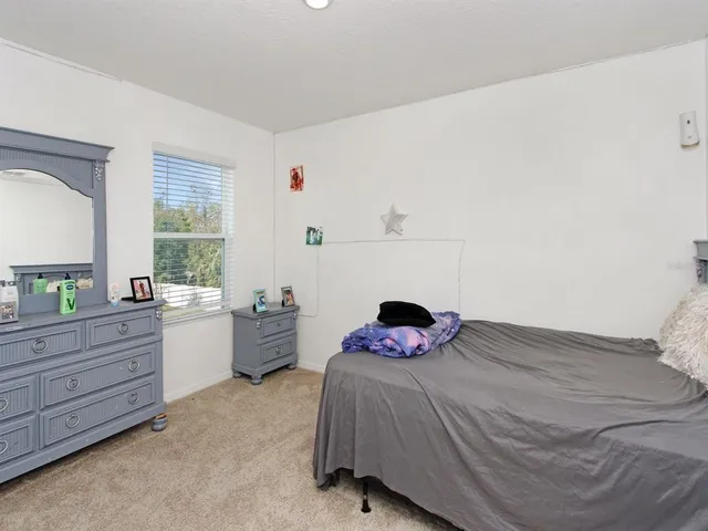 a bedroom with a bed and a closet