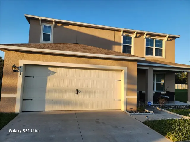 a living room with a rug and a floor to ceiling window