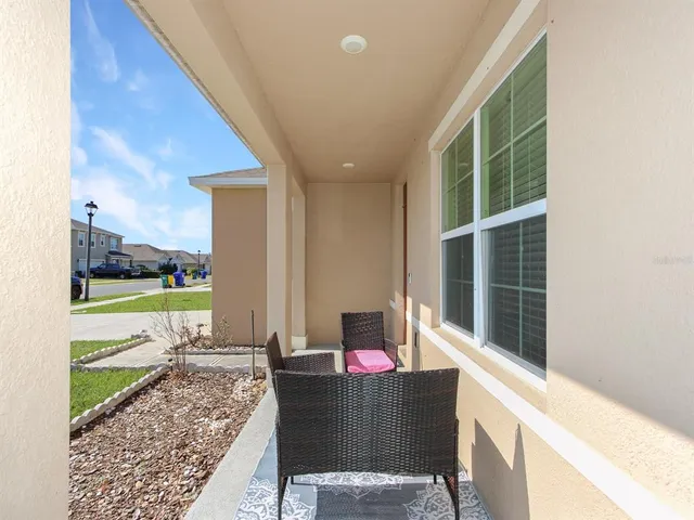 a view of a house with backyard porch and sitting area