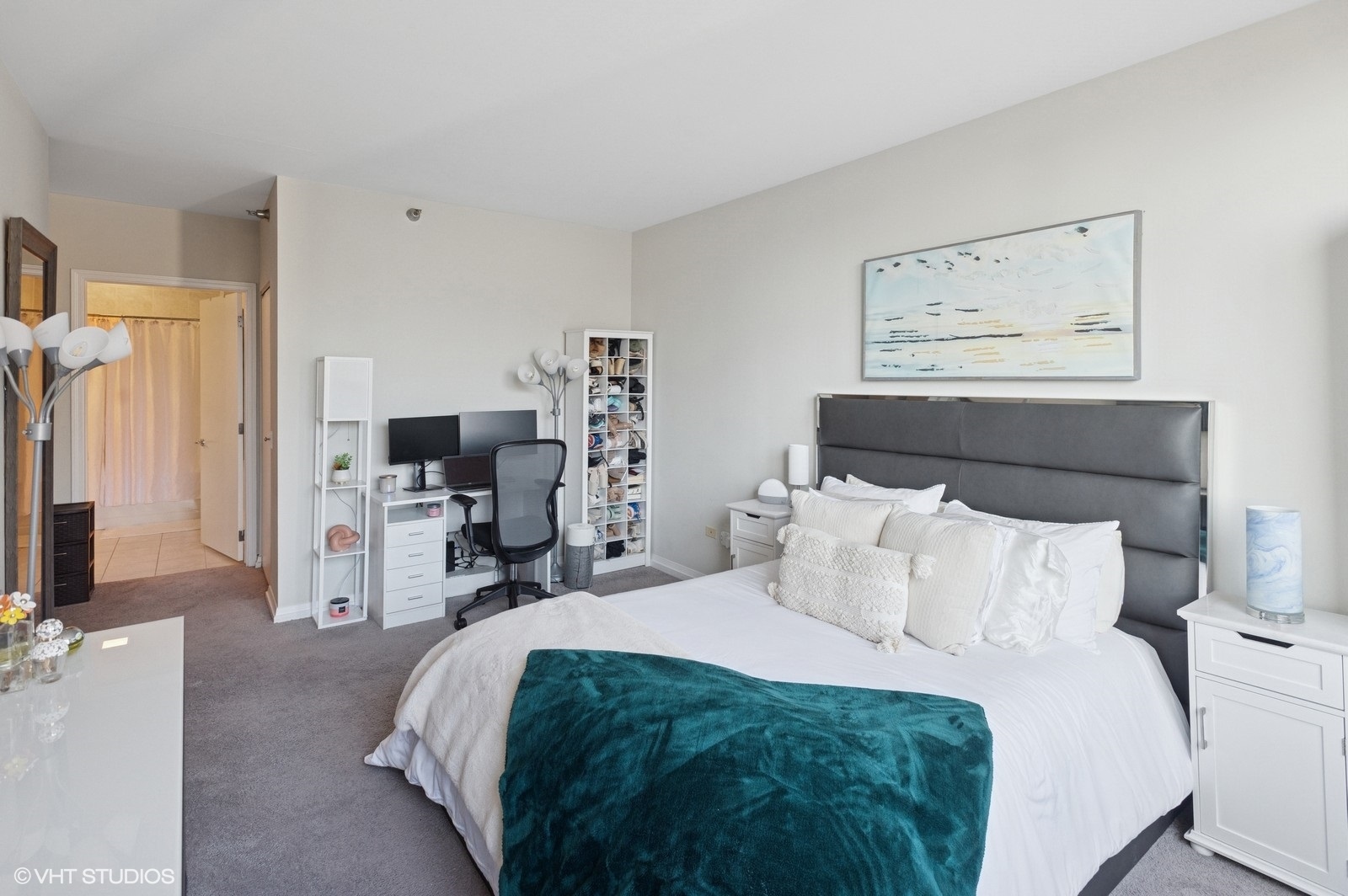 33 West Ontario Street, Unit 40D Chicago, IL 60654 - Photo 17 of 40 a bedroom with a bed and a flat tv screen on the dresser