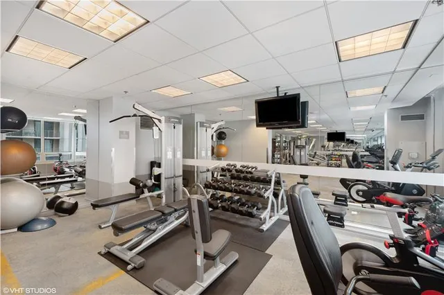 a room with gym equipment and a flat screen tv