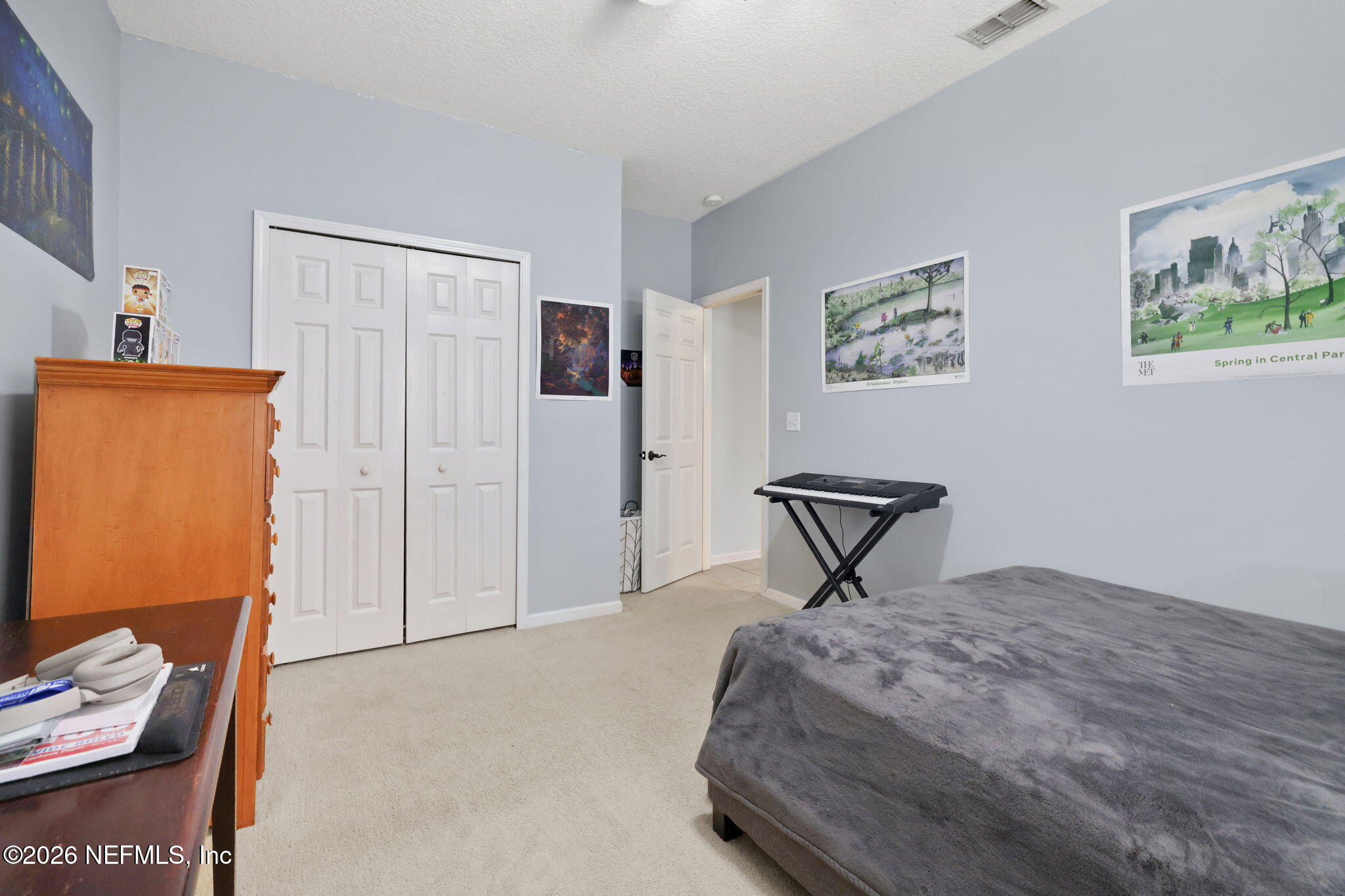 4320 Rye Court St. Johns, FL 32259 - Photo 41 of 60 a bedroom with a bed and a table in it