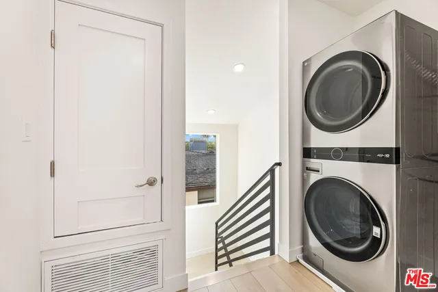 a view of a hallway with washer and dryer