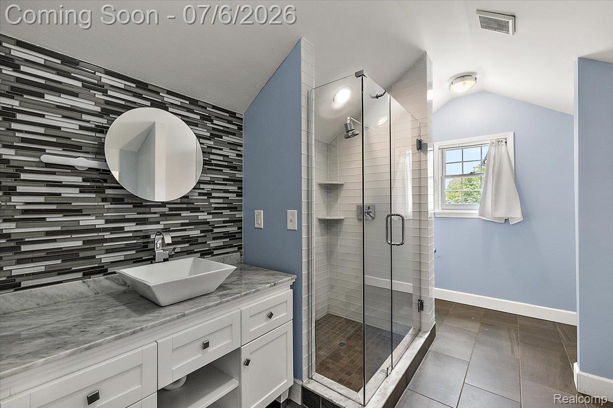 1051 Devonshire Road Grosse Pointe, MI 48230 - Photo 60 of 98 Bathroom featuring a white vanity with a rectangular vessel sink, a stone countertop, and a glass-enclosed shower with subway tile surround