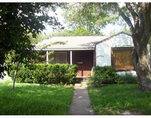 a front view of house with a garden