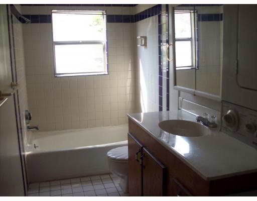 3539 Austin Street Corpus Christi, TX 78411 - Photo 3 of 4 a bathroom with a granite countertop sink a bathtub and window