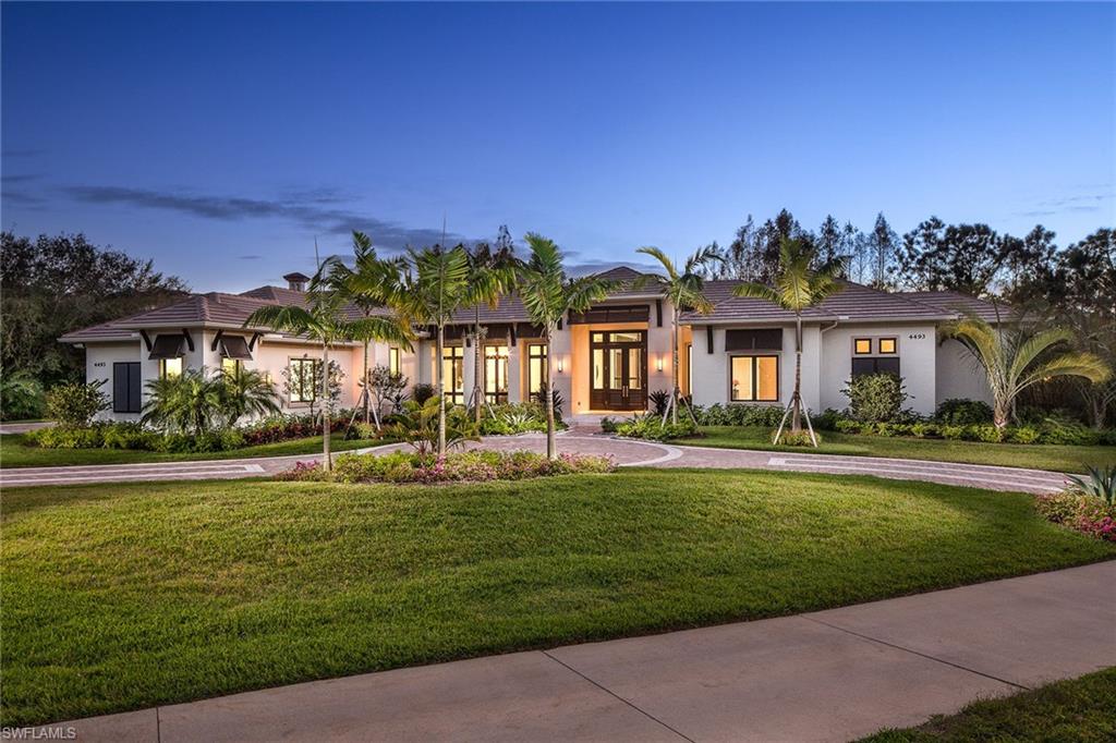 a front view of a house with a yard table and chairs