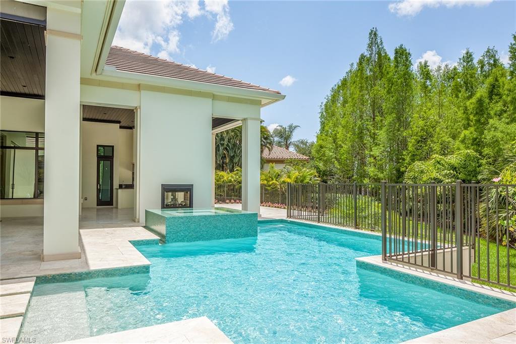 4493 Wayside Drive Naples, FL 34119 - Photo 22 of 24 a view of a house with backyard and porch