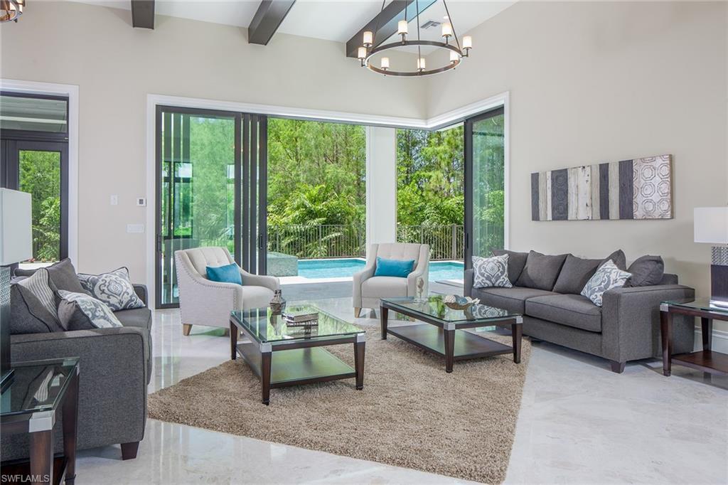4493 Wayside Drive Naples, FL 34119 - Photo 8 of 24 a living room with furniture and a large window