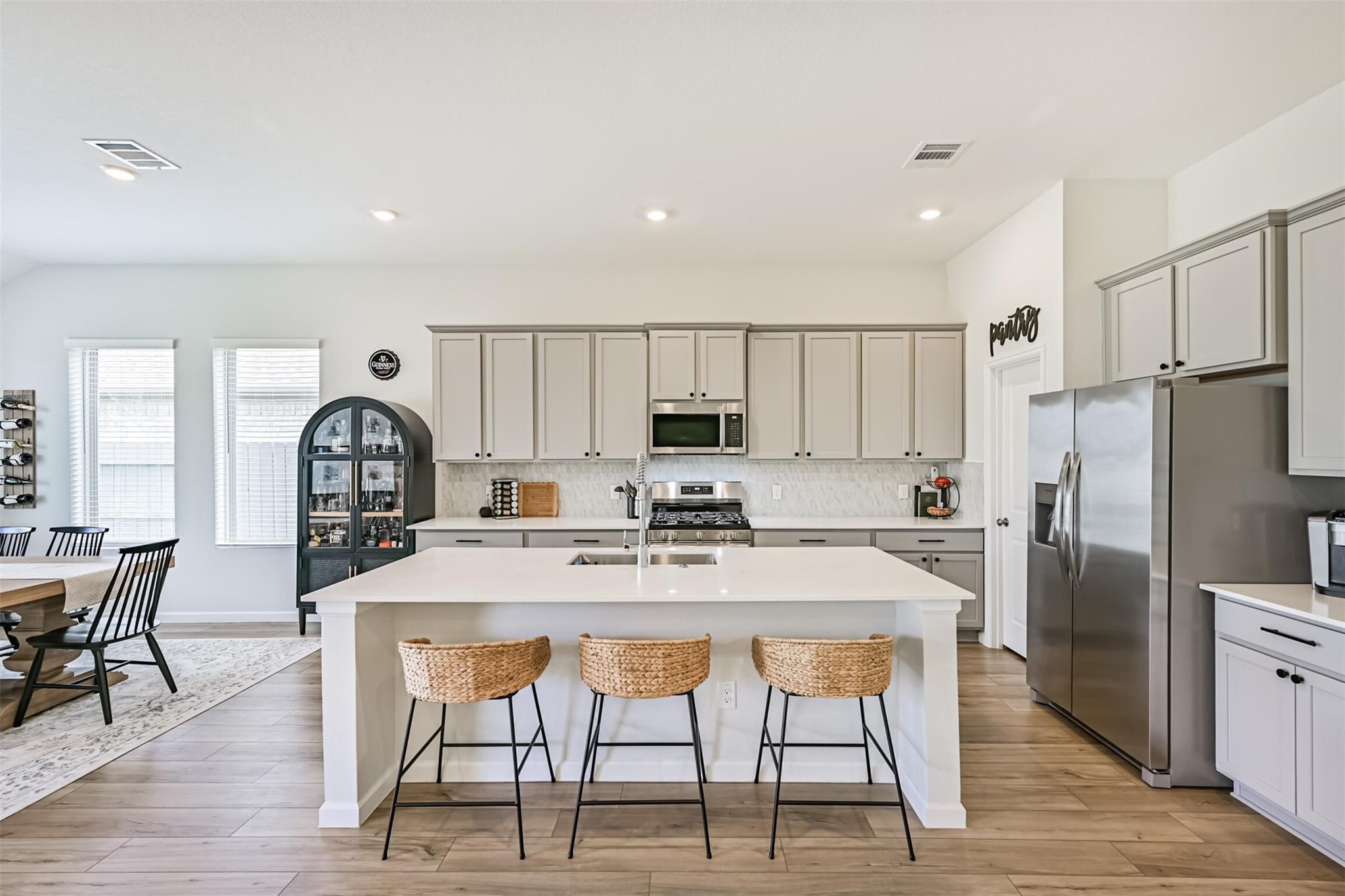 5010 Walnut Grv Lane Manvel, TX 77578 - Photo 19 of 46 a kitchen with stainless steel appliances granite countertop a stove a refrigerator a white table and chairs