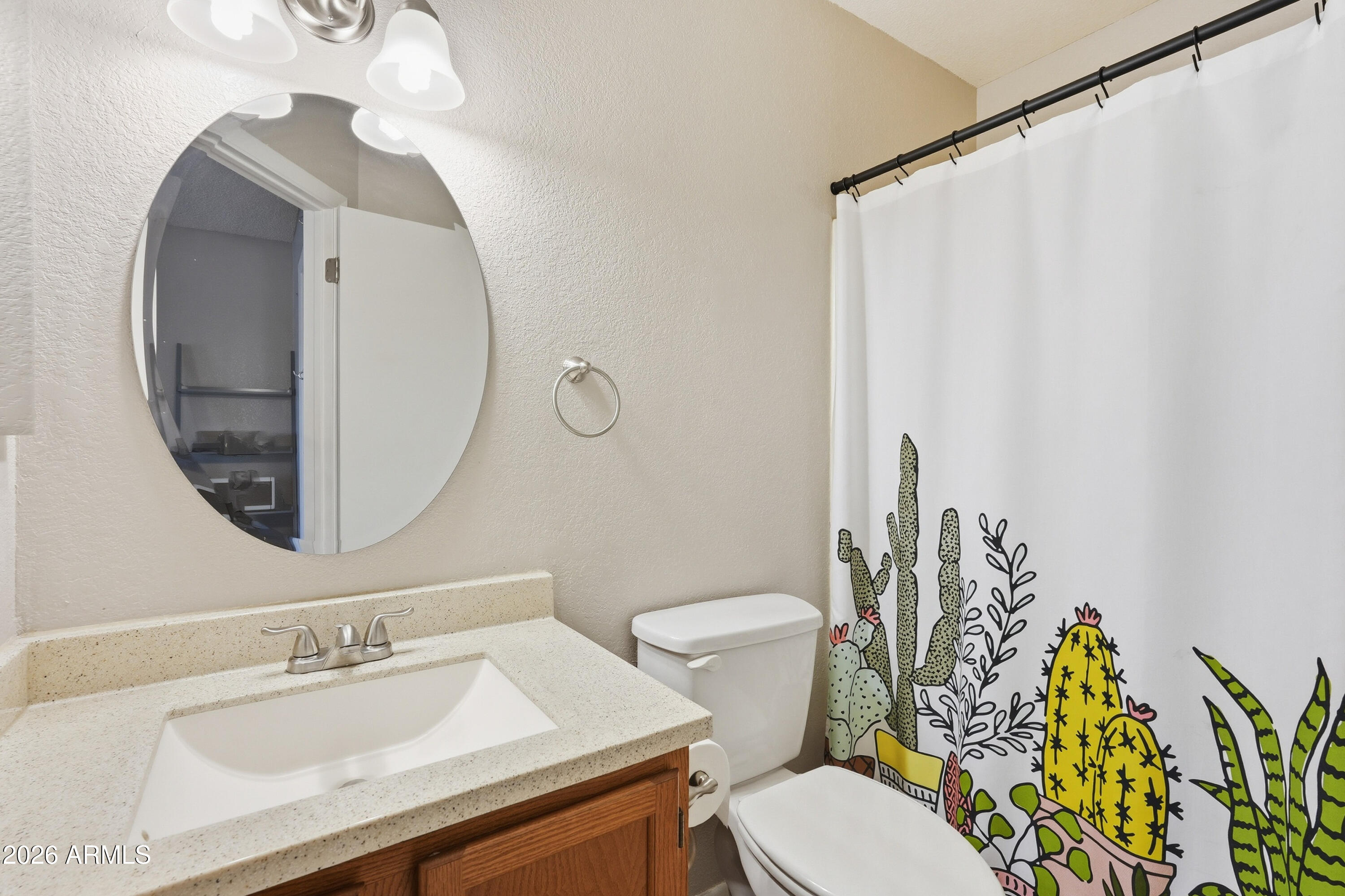 14300 West Bell Road, Unit 49 Surprise, AZ 85374 - Photo 11 of 19 a bathroom with a sink mirror vanity and toilet