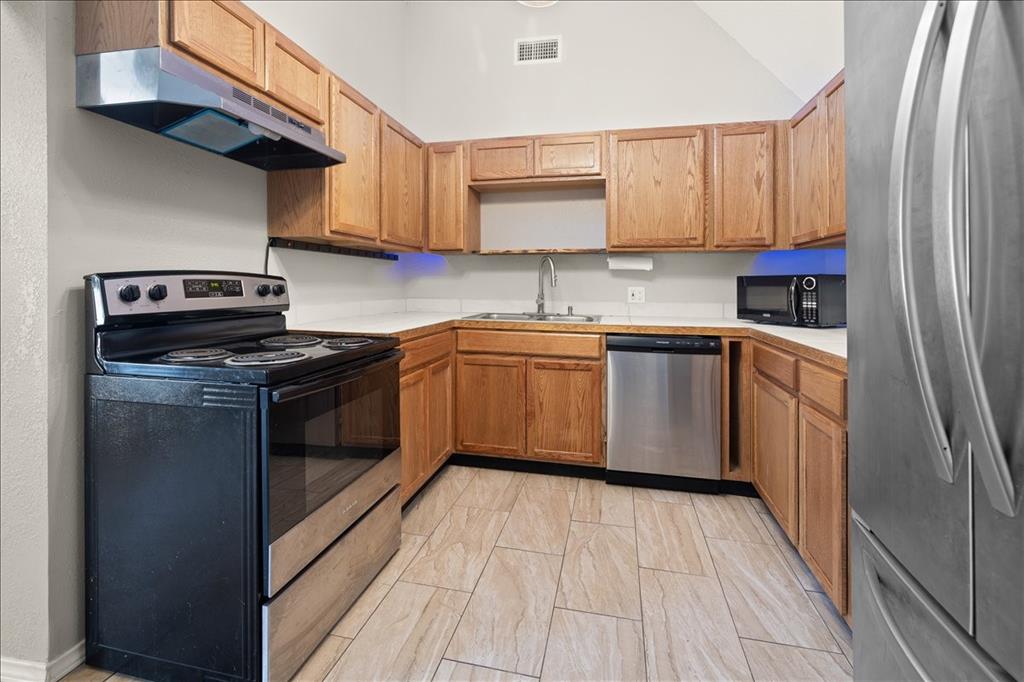 100 Sands Drive Azle, TX 76020 - Photo 14 of 31 a kitchen with stainless steel appliances granite countertop a stove sink and cabinets