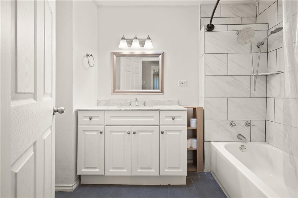 100 Sands Drive Azle, TX 76020 - Photo 19 of 31 a bathroom with a tub sink and mirror