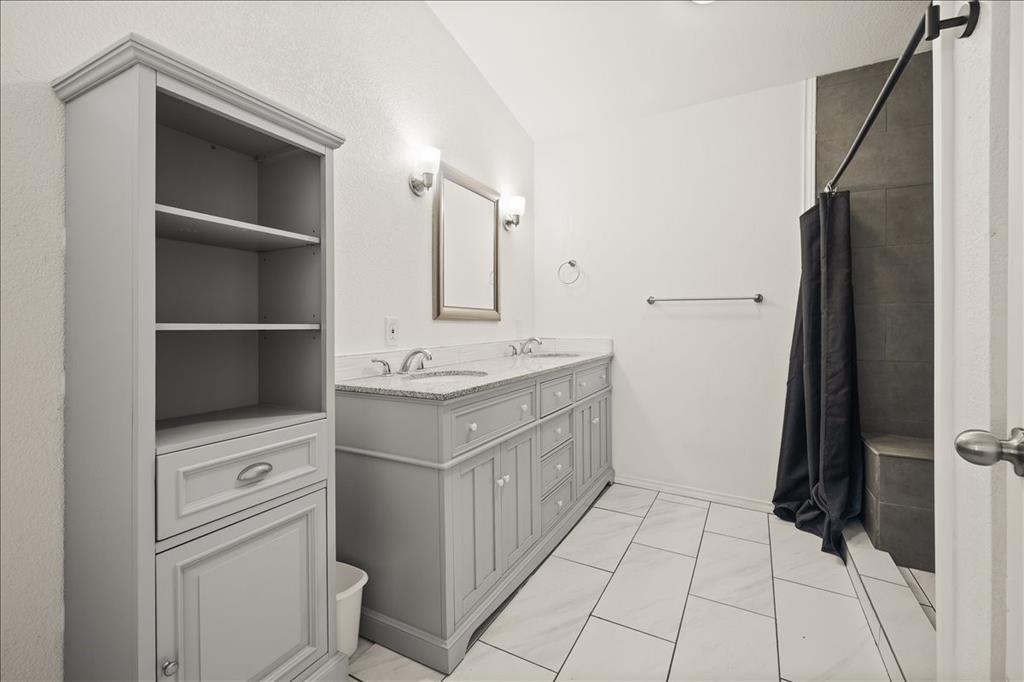 100 Sands Drive Azle, TX 76020 - Photo 25 of 31 a bathroom with a sink a toilet and a shower