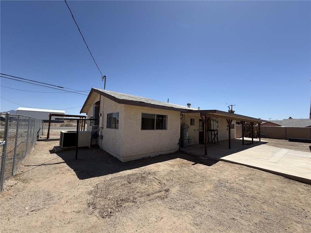 15691 Apache Loop Ehrenberg, AZ 85334 - Photo 22 of 24 Stucco-finished exterior with a gabled roofline and an extended covered patio