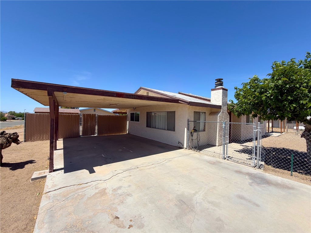 15691 Apache Loop Ehrenberg, AZ 85334 - Photo 3 of 24 Concrete driveway with a covered carport structure