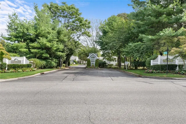 front view of a house with a yard and trees