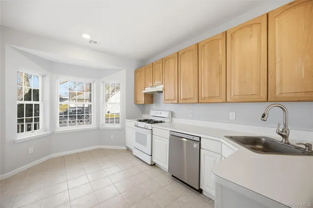a kitchen with a sink cabinets and window