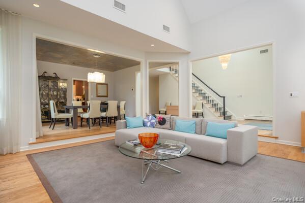 19 West Gate Road Suffern, NY 10901 - Photo 15 of 42 Vaulted living room featuring light wood-finish flooring, a contemporary rug, and recessed lighting