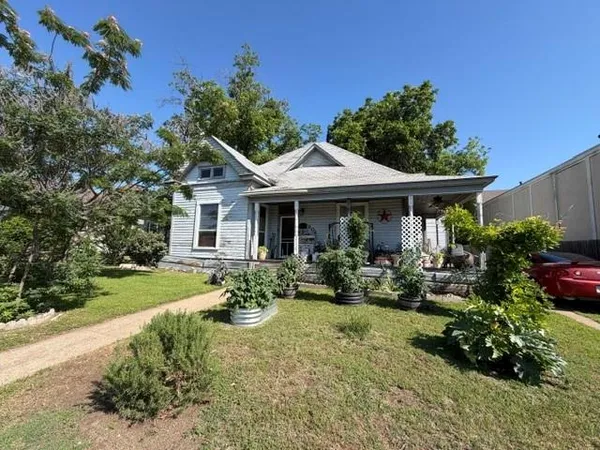 a front view of a house with garden and porch