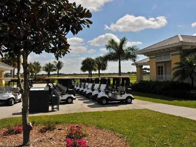 a view of a lake with a big yard and large trees
