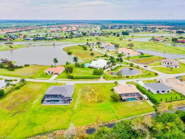 an aerial view of a resort with swimming pool and ocean view