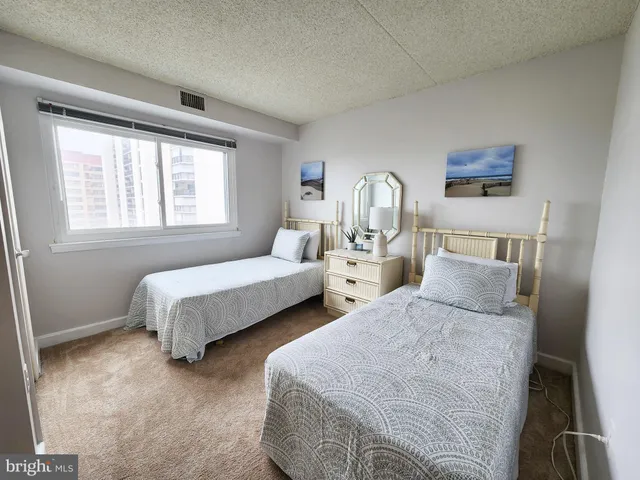 a bedroom with two beds and a window