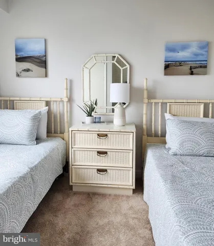 a bedroom with a bed a mirror and lamp