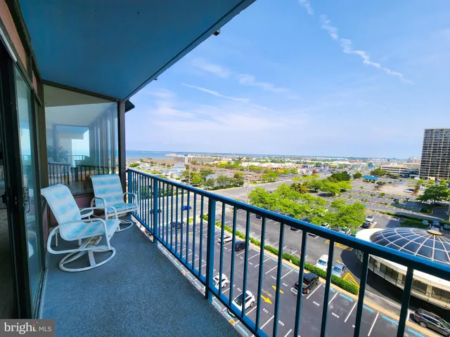 a view of a chairs and table in the balcony