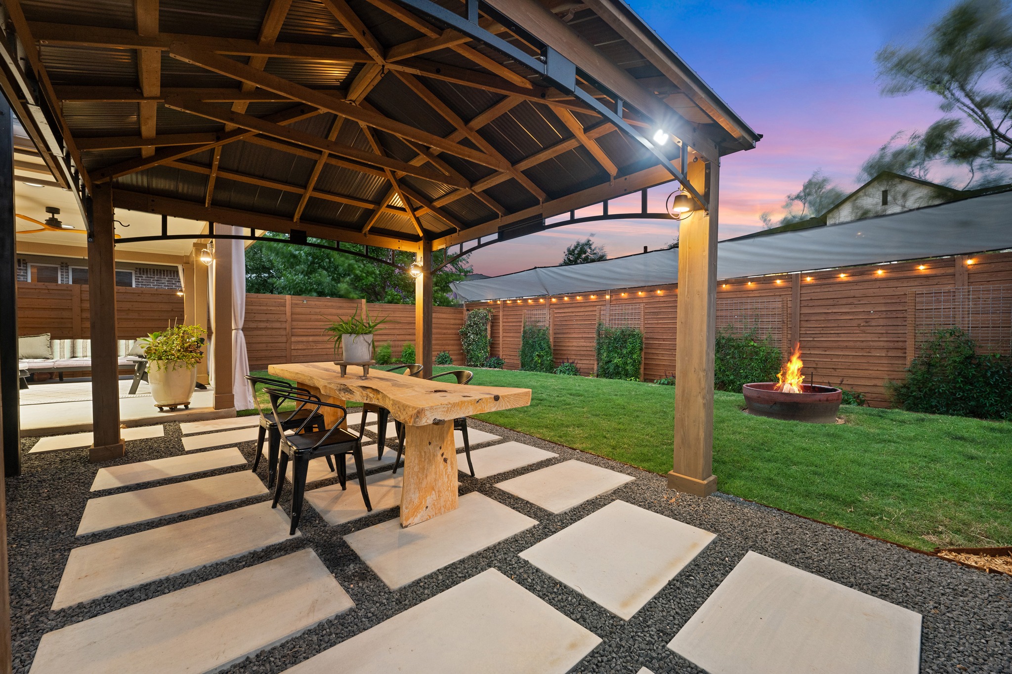 a view of a patio with table and chairs under an umbrella
