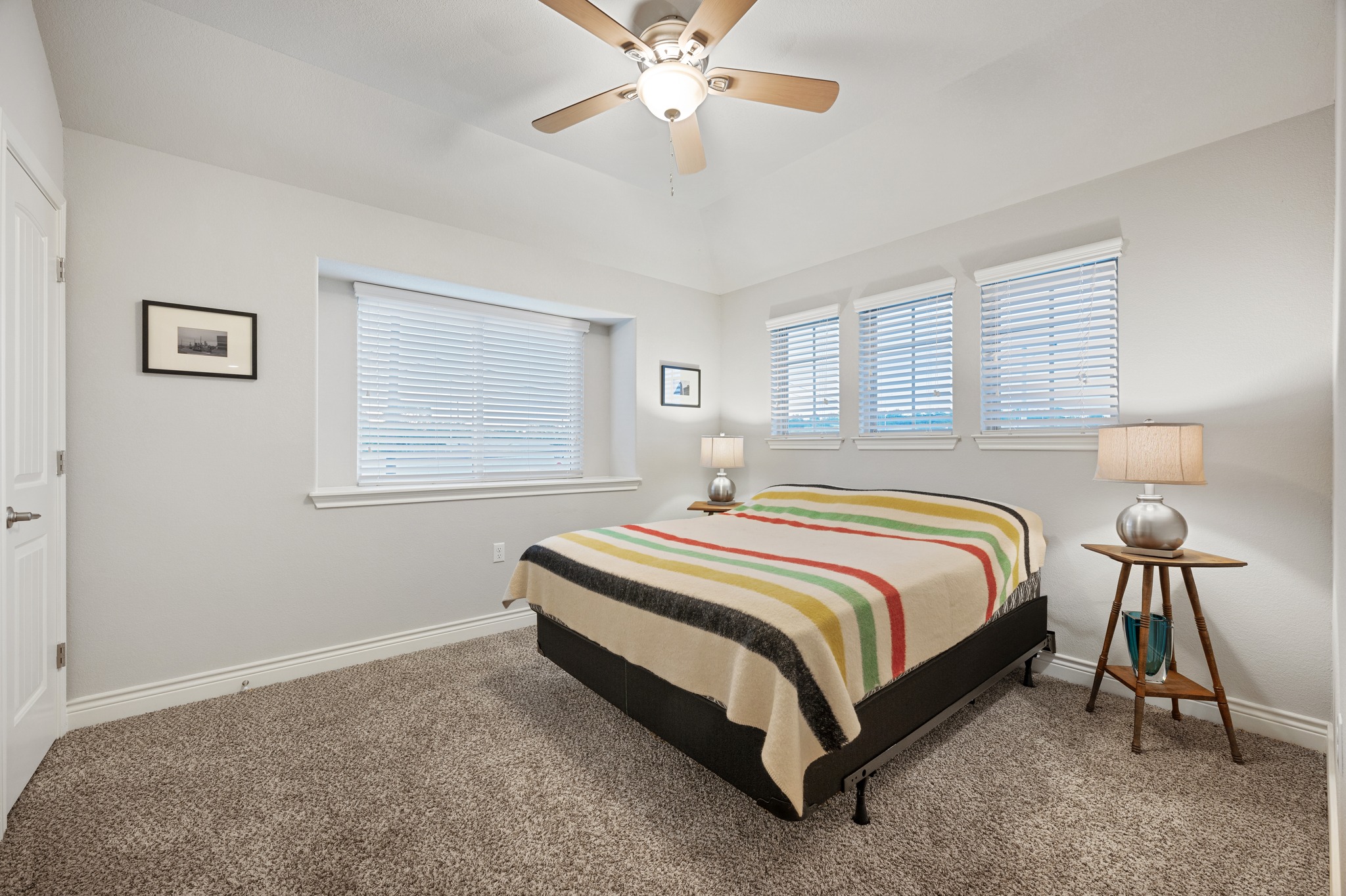 6405 Alleyton Drive Austin, TX 78721 - Photo 14 of 30 a bedroom with a bed and a chandelier