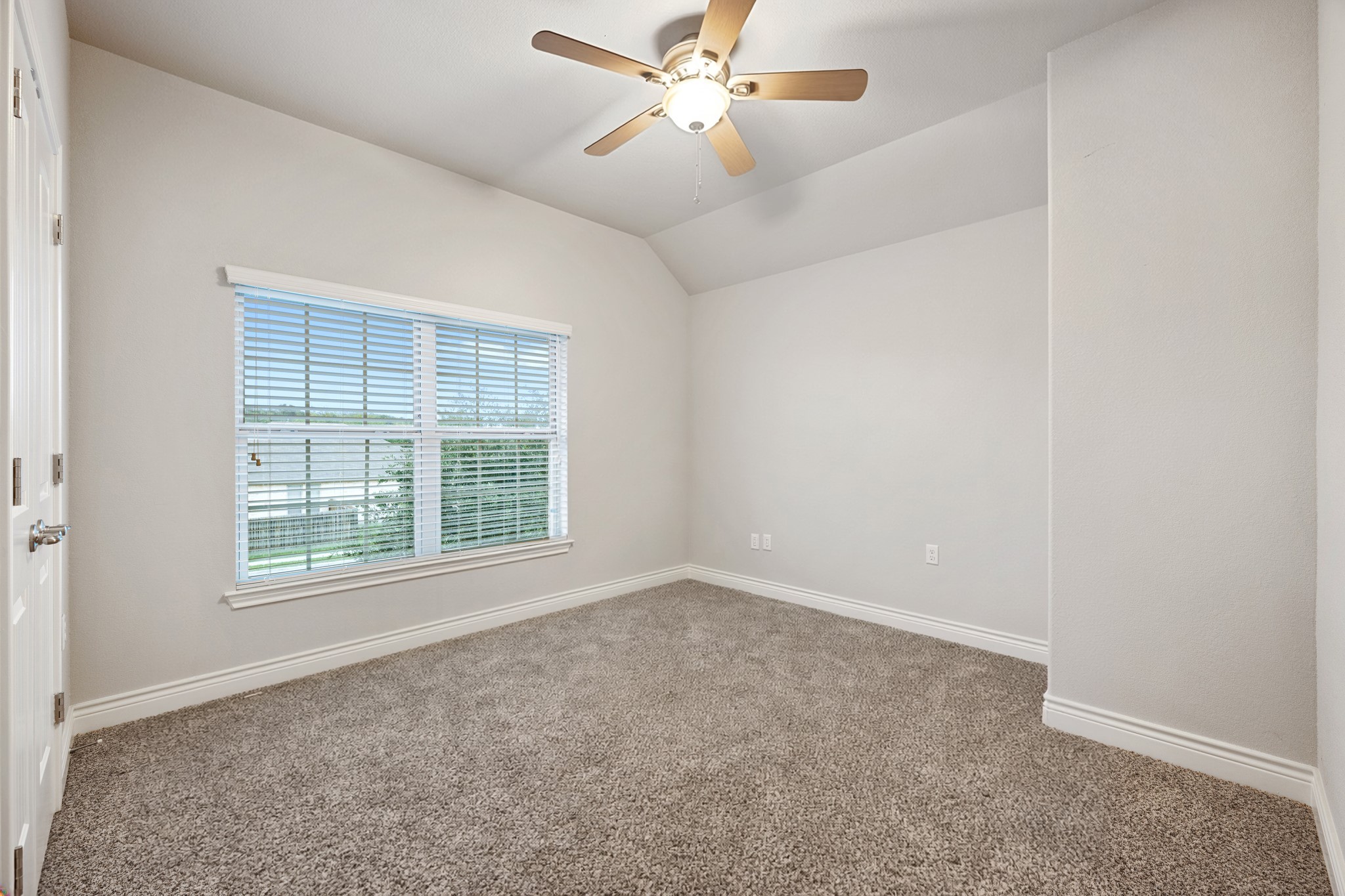 6405 Alleyton Drive Austin, TX 78721 - Photo 15 of 30 an empty room with chandelier fan and windows