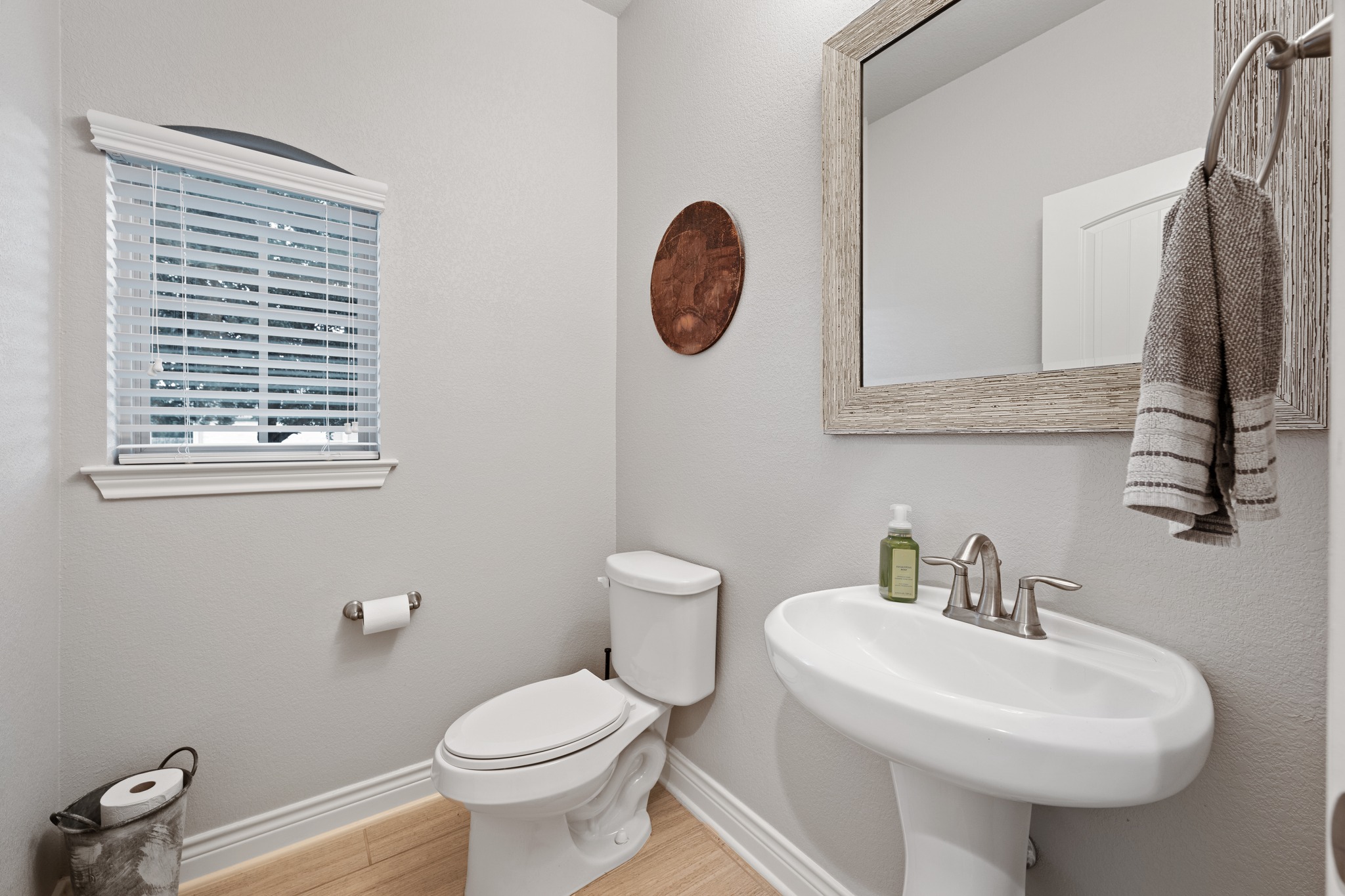 6405 Alleyton Drive Austin, TX 78721 - Photo 19 of 30 a bathroom with a toilet sink and mirror