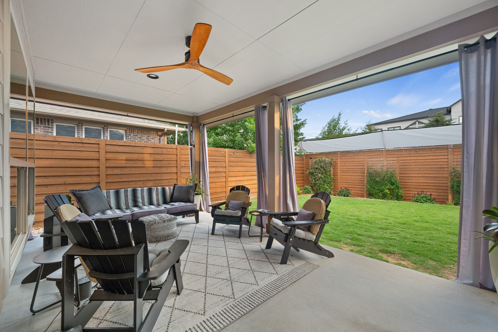 6405 Alleyton Drive Austin, TX 78721 - Photo 22 of 30 a living room with patio furniture and a yard