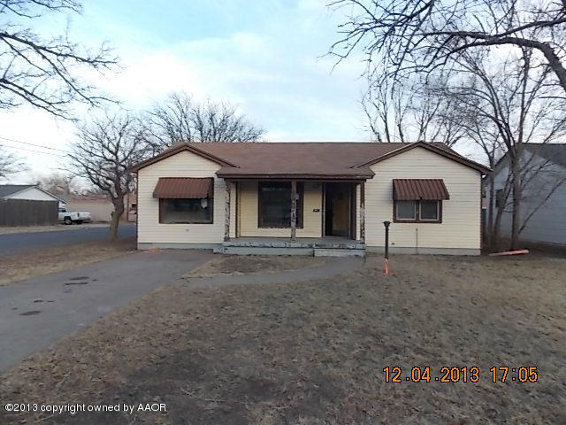 4101 South Travis Street Amarillo, TX 79110 - Photo 1 of 14 a front view of a house with a yard and garage
